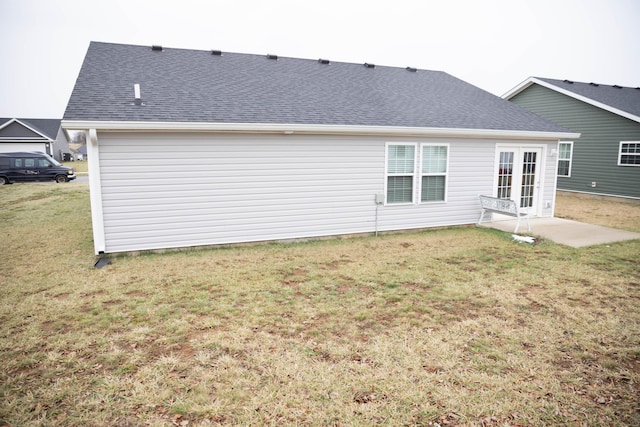 rear view of property with a lawn and french doors