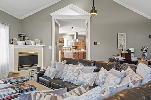 living room with crown molding, a high end fireplace, vaulted ceiling, and hardwood / wood-style flooring