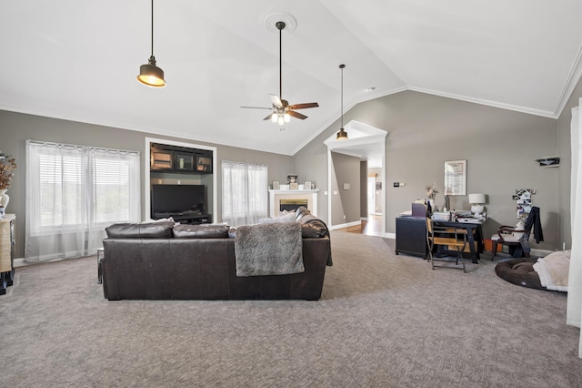 living room featuring vaulted ceiling, carpet floors, ceiling fan, and ornamental molding