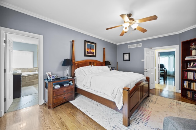 bedroom featuring ceiling fan, ornamental molding, ensuite bath, and light hardwood / wood-style flooring