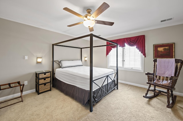 bedroom featuring crown molding, ceiling fan, and light carpet