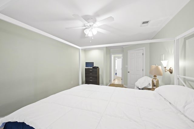 bedroom with ceiling fan and ornamental molding