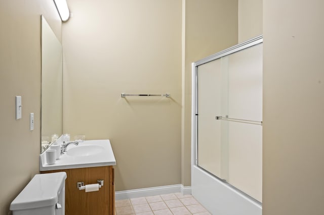 bathroom with vanity, tile patterned flooring, and combined bath / shower with glass door