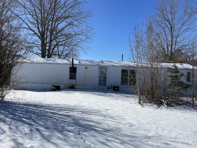 view of snow covered rear of property