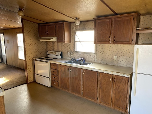 kitchen featuring white appliances and sink