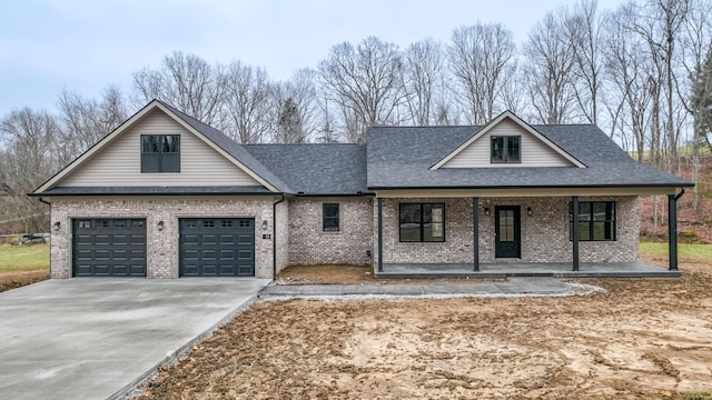 view of front of property with a garage and covered porch