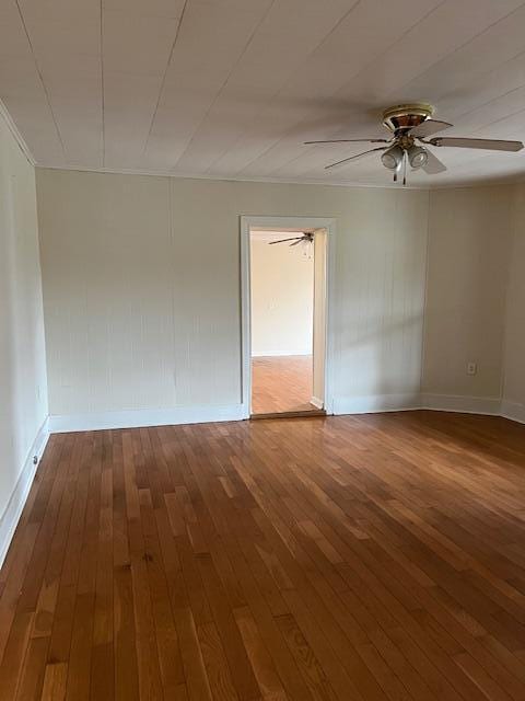 empty room with ceiling fan and hardwood / wood-style floors