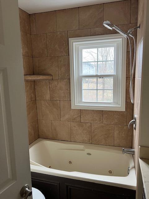 bathroom featuring  shower combination