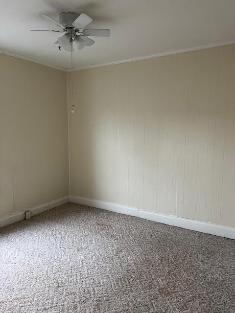 spare room with ornamental molding, carpet flooring, and ceiling fan