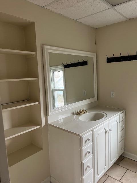 bathroom featuring vanity, tile patterned flooring, and a paneled ceiling