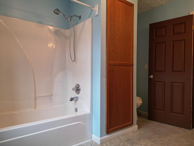 bathroom featuring  shower combination, toilet, and a textured ceiling