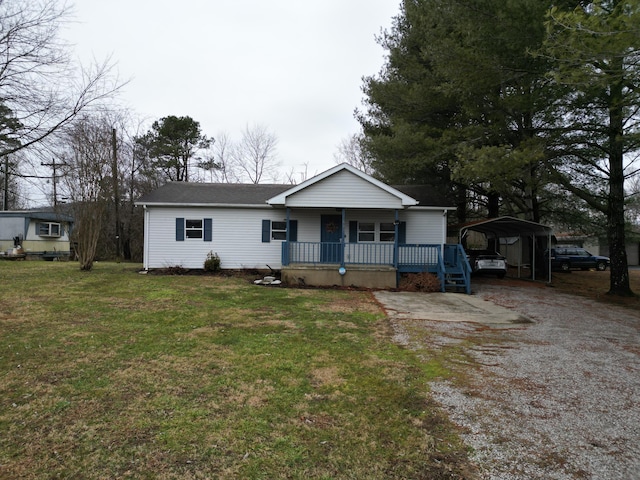 single story home featuring a porch, a carport, and a front lawn