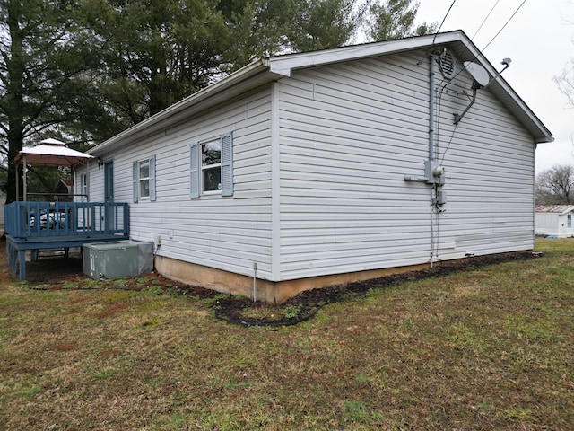 view of side of property with a gazebo, a deck, and a lawn