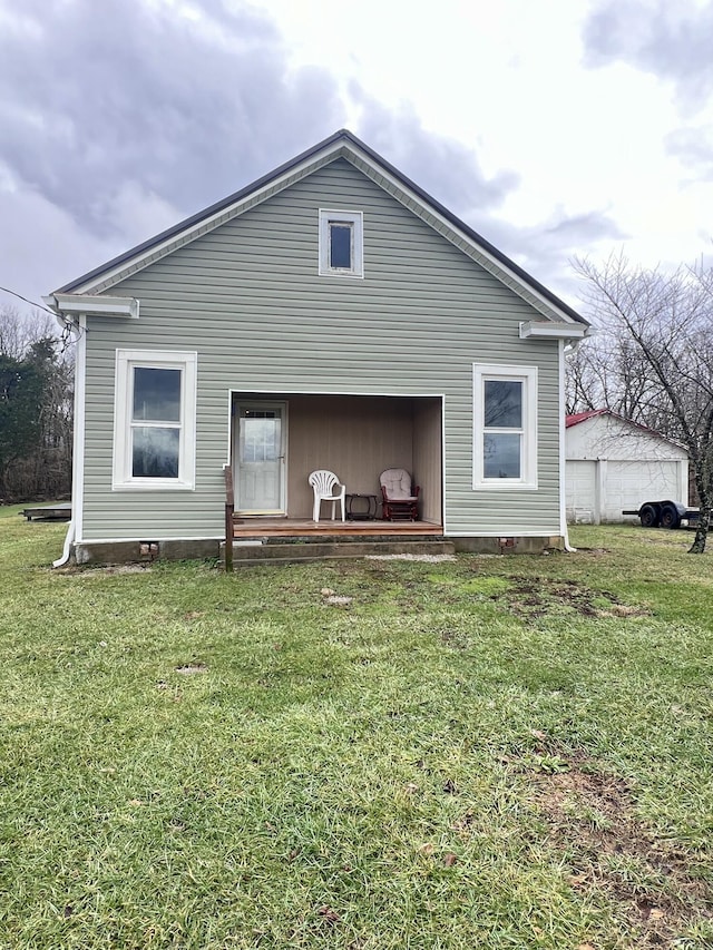 rear view of house featuring a yard