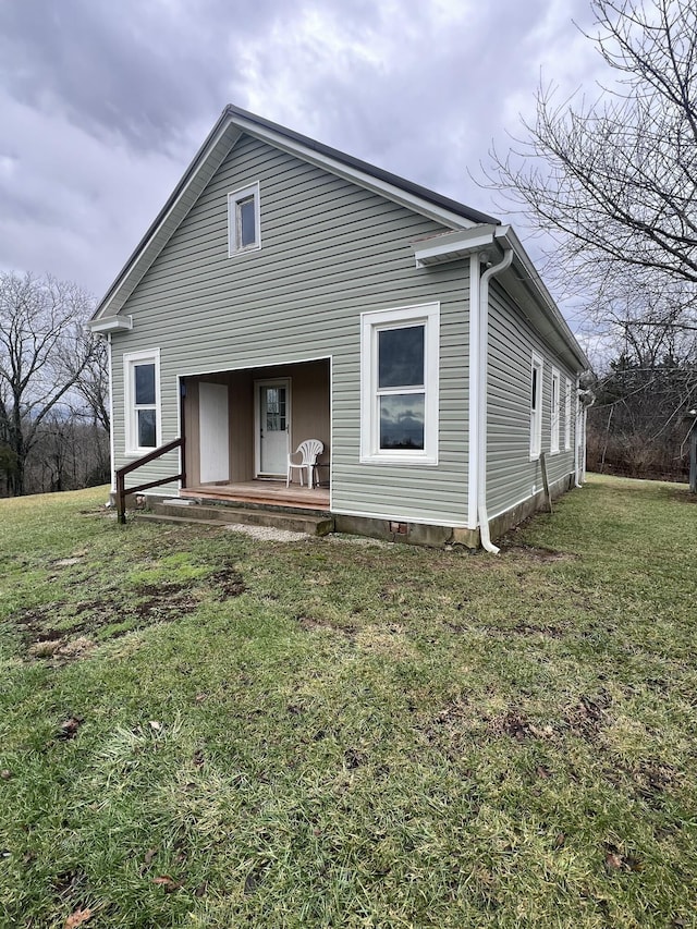 rear view of property with a lawn