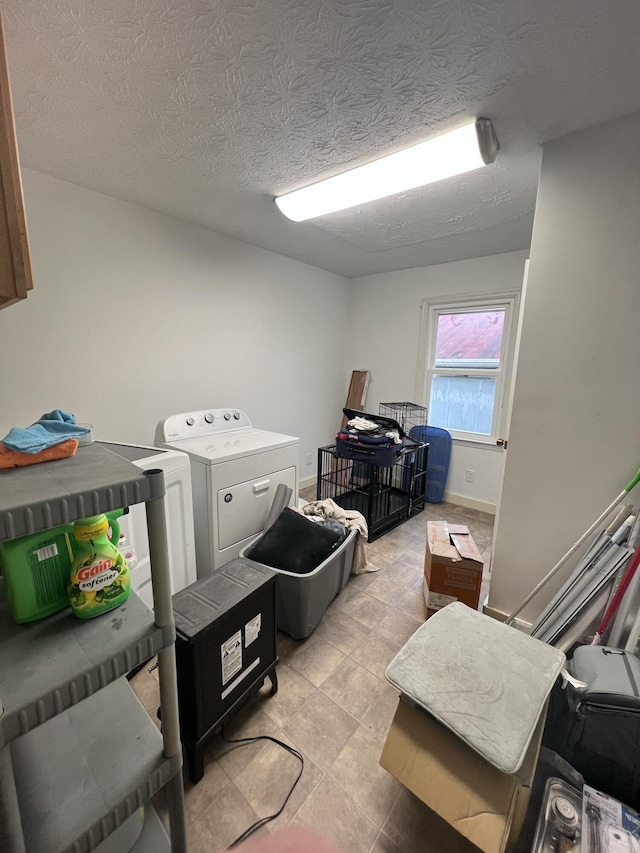 interior space with washing machine and clothes dryer and a textured ceiling