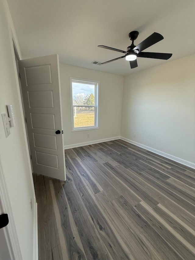 unfurnished room featuring dark hardwood / wood-style flooring and ceiling fan