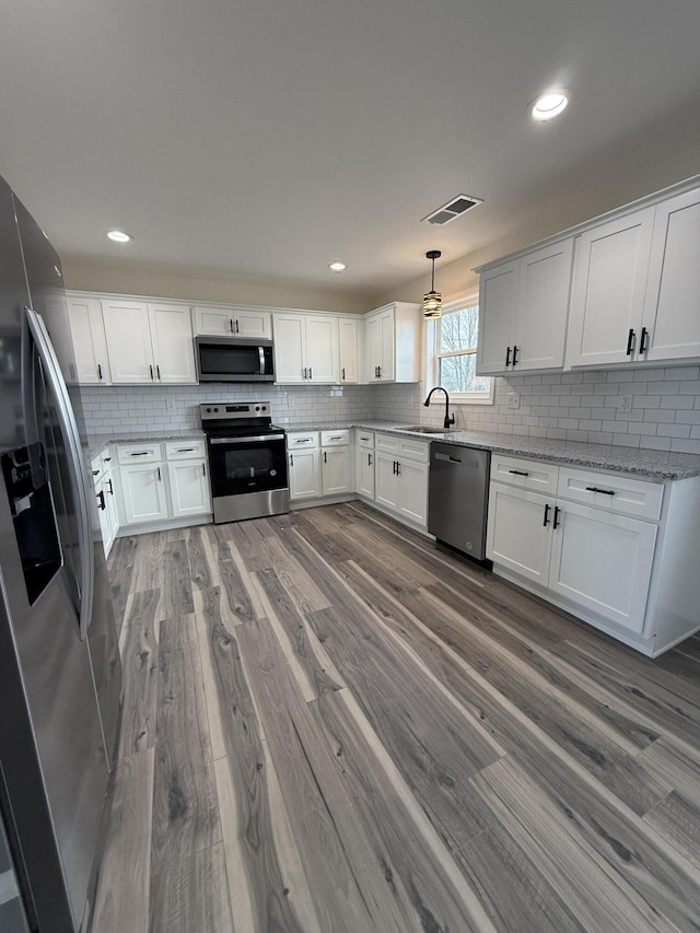 kitchen featuring white cabinetry and appliances with stainless steel finishes