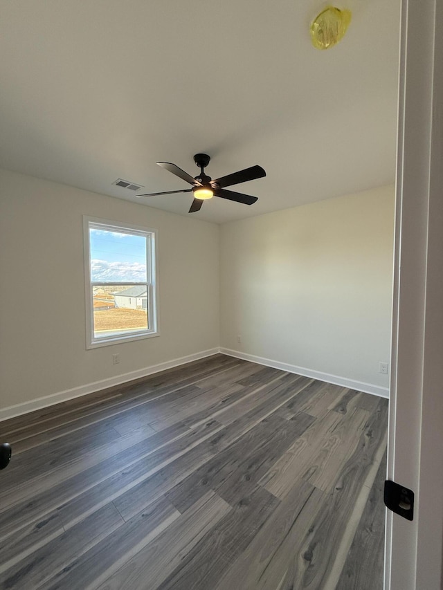 unfurnished room featuring ceiling fan and dark hardwood / wood-style flooring