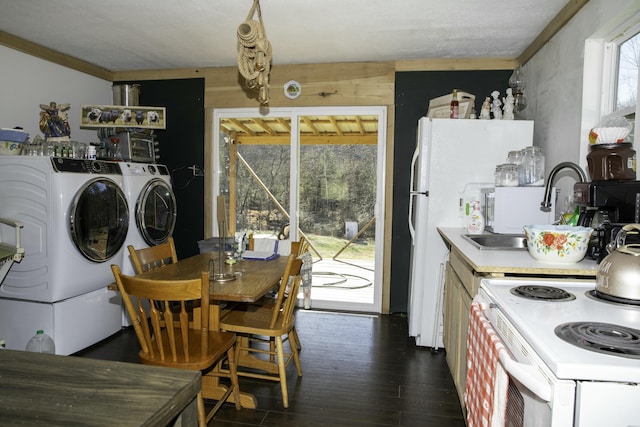 kitchen featuring white appliances, dark hardwood / wood-style floors, sink, and washer and dryer