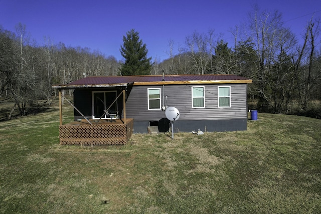 rear view of house featuring a lawn