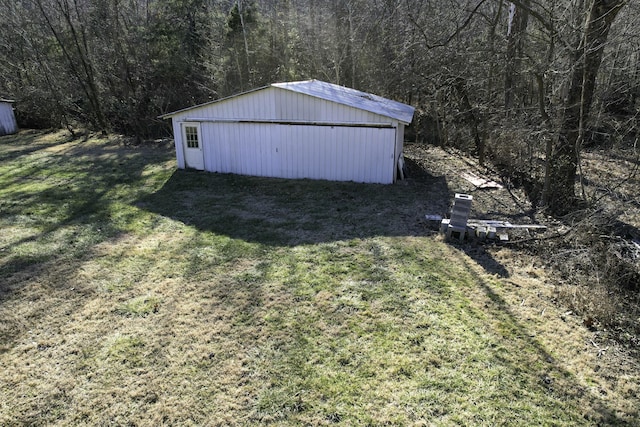 view of outbuilding featuring a lawn