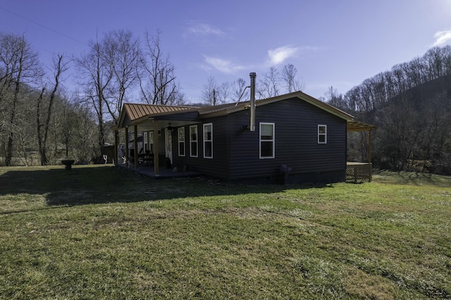 view of property exterior with a yard