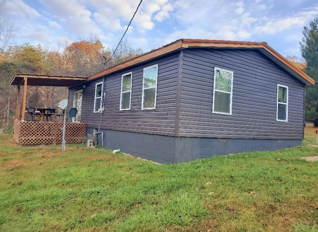 view of side of home with a yard