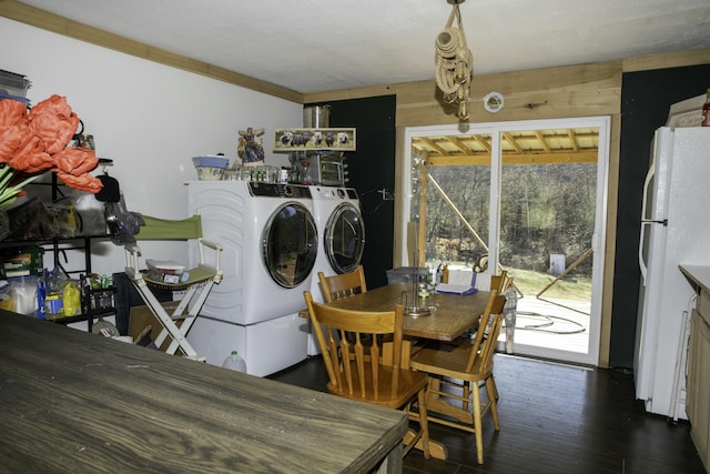 clothes washing area with separate washer and dryer and dark hardwood / wood-style floors