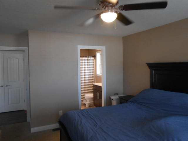 bedroom featuring ensuite bathroom, ceiling fan, and a closet