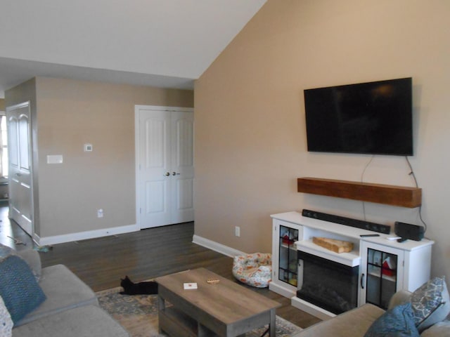 living room with vaulted ceiling and dark wood-type flooring