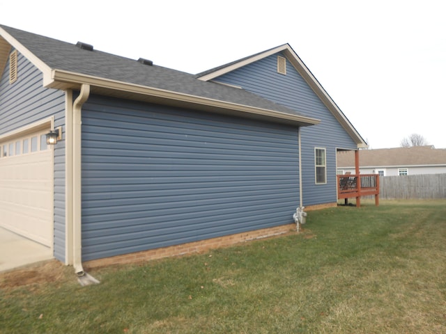 view of home's exterior featuring a garage and a lawn