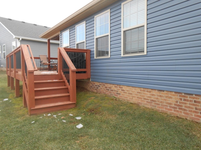 exterior space with a wooden deck and a lawn