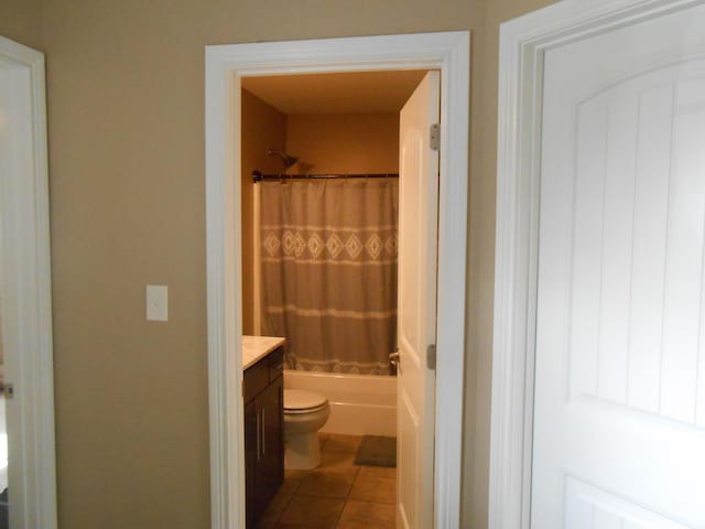 full bathroom featuring shower / bath combination with curtain, vanity, toilet, and tile patterned flooring