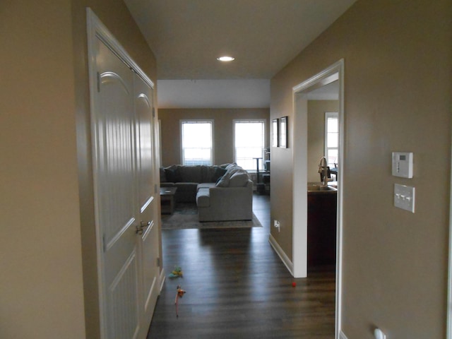 corridor with dark hardwood / wood-style flooring