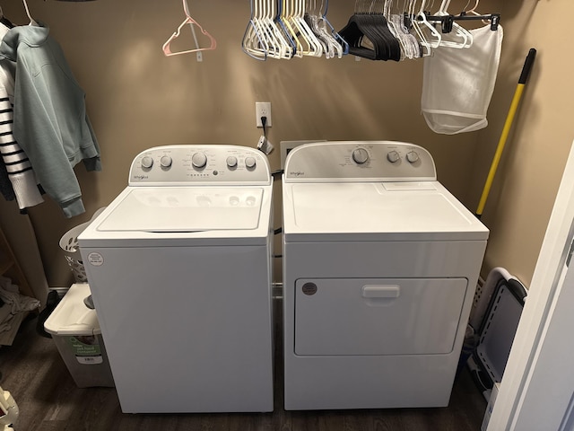 clothes washing area featuring washer and dryer and dark wood-type flooring