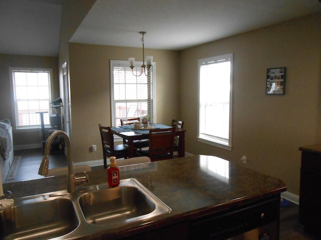 kitchen featuring sink, a notable chandelier, and hanging light fixtures