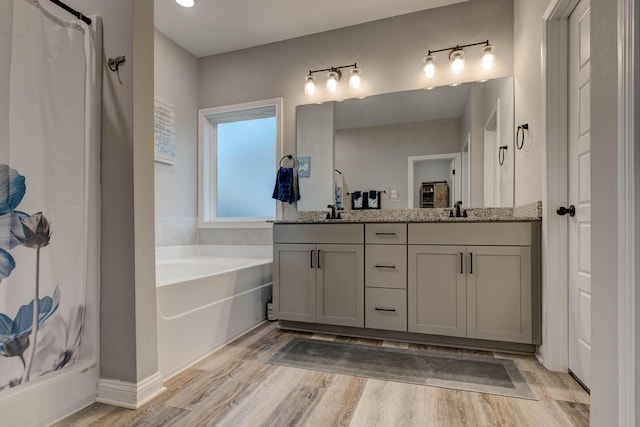 bathroom with vanity, separate shower and tub, and hardwood / wood-style floors