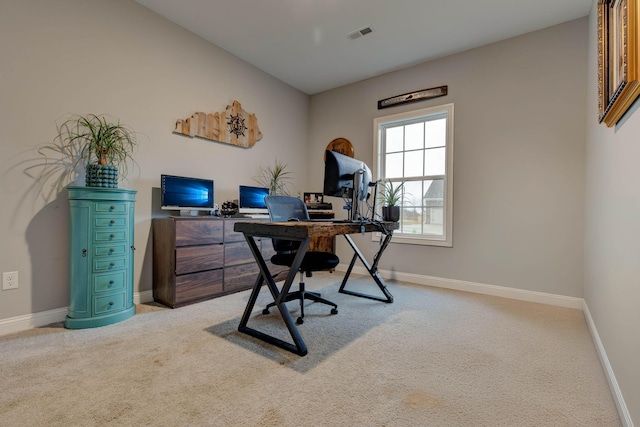 office space featuring light carpet, visible vents, and baseboards