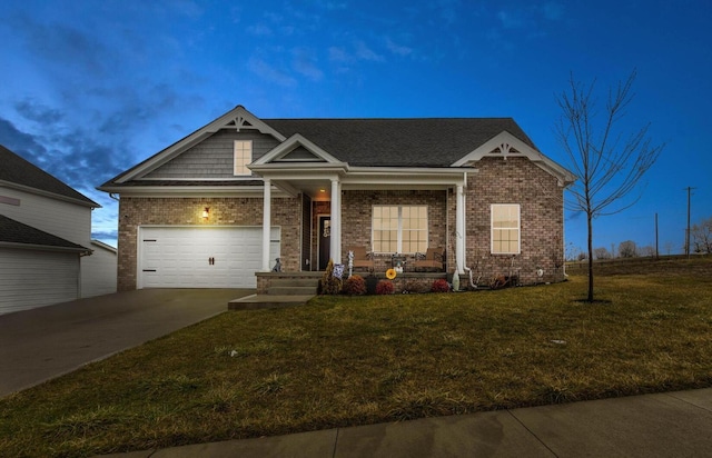 craftsman house featuring brick siding, covered porch, a garage, driveway, and a front lawn