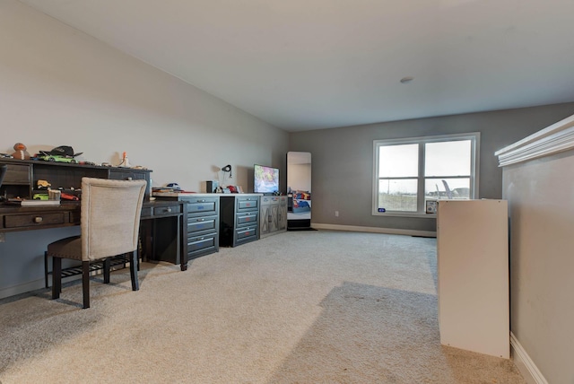 home office featuring baseboards and light colored carpet