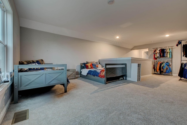 carpeted bedroom featuring baseboards, visible vents, and recessed lighting