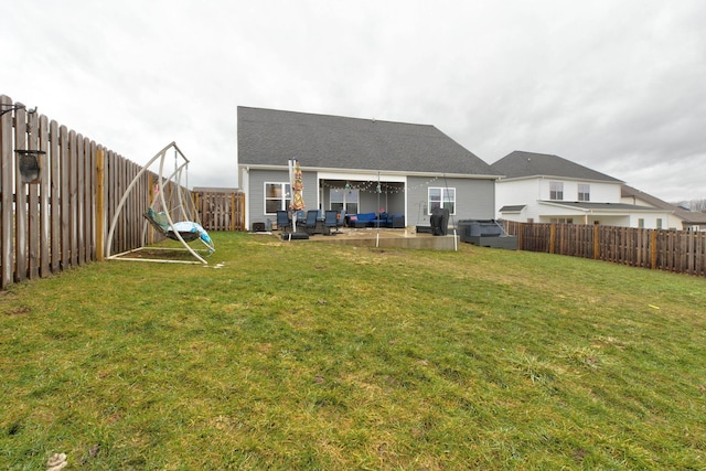 back of property featuring an outdoor living space, a patio area, and a lawn