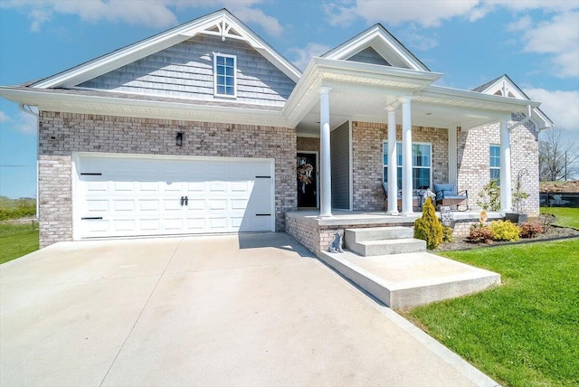 view of front of home featuring a front lawn, driveway, a porch, and a garage