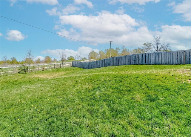 view of yard with a rural view and fence