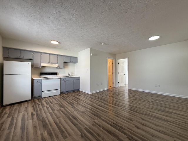 kitchen with sink, white appliances, gray cabinetry, a textured ceiling, and dark hardwood / wood-style flooring