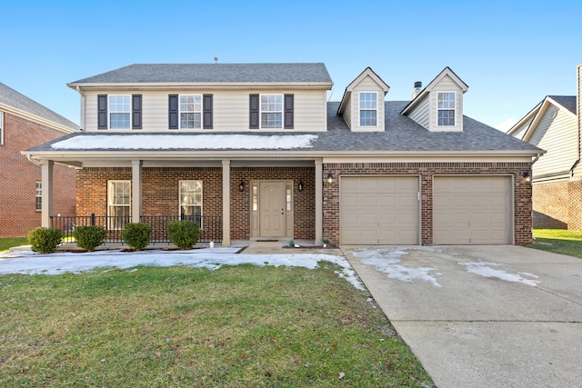 view of front facade featuring a garage, covered porch, and a front lawn