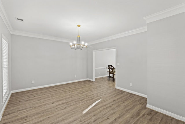 unfurnished dining area featuring ornamental molding, light wood-type flooring, and a chandelier