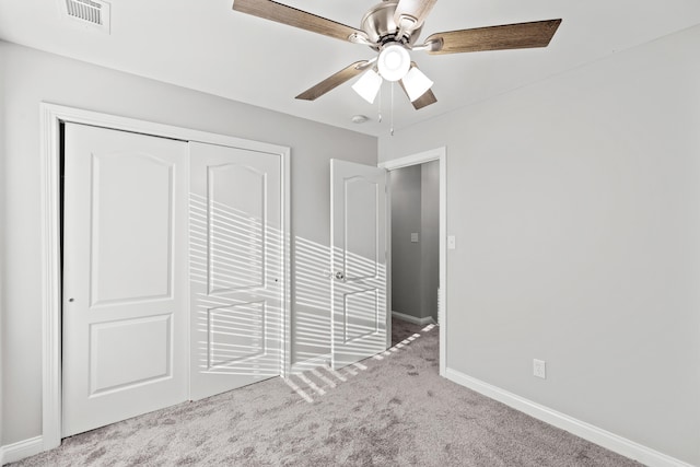 unfurnished bedroom with carpet flooring, ceiling fan, and a closet