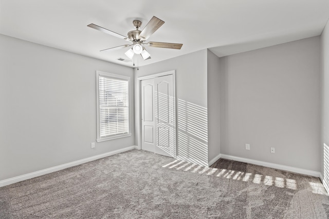 empty room with carpet and ceiling fan